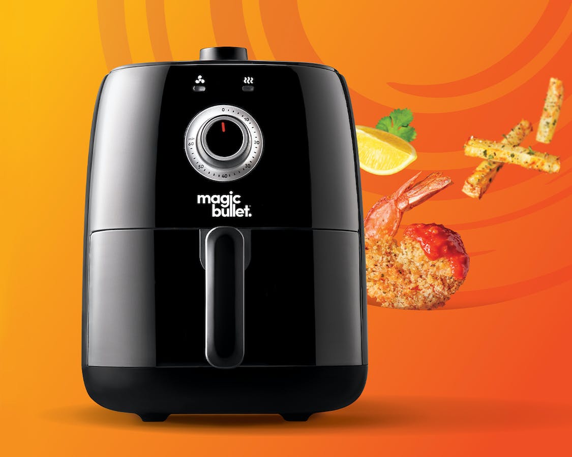 magic bullet air fryer against an bright orange background.