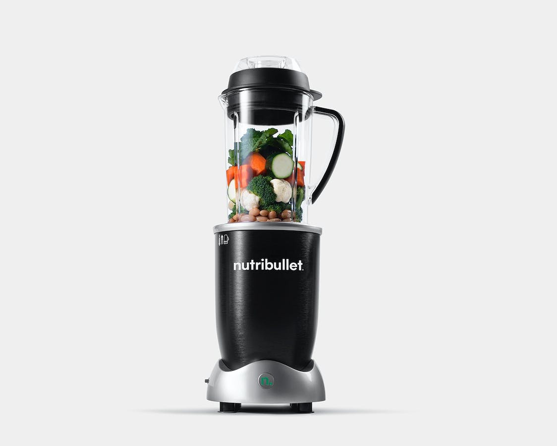 nutribullet Rx with vegetables and beans on grey background.